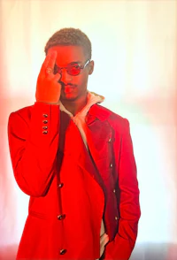 a man in a red jacket with glasses