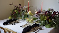 a table setting with candles and flowers