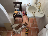 a bathroom with a sink and a chair