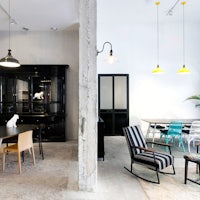 a room with a dining table and chairs