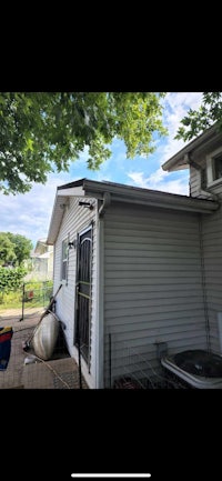 a house with a roof and a fenced in yard