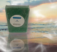 a bag of green soap sitting on the beach