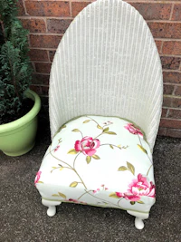 a wicker chair with a floral pattern on it