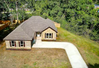 an aerial view of a home in the woods