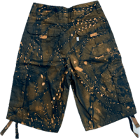 a pair of men's cargo shorts with splatters on them