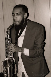 a black and white photo of a man playing a saxophone