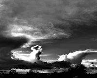 a black and white photo of clouds in the sky