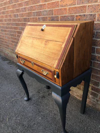 a desk with a wooden top and black legs