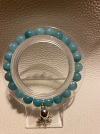 a bracelet with a blue bead on it