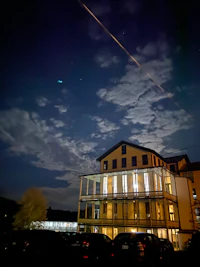 a plane flying over a building at night