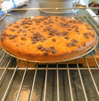 a chocolate chip cake sitting on a cooling rack