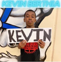 a young boy holding up a sign that says kevin berthia
