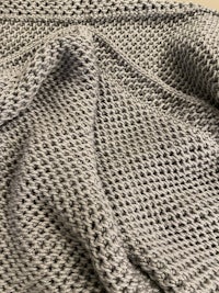 a close up of a grey knitted blanket