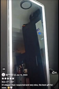 a mirror in a bathroom with a light on it