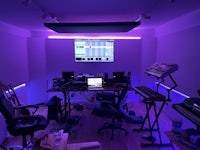 a room with purple lighting and a computer
