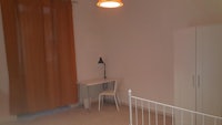 a small room with a chair and a lamp