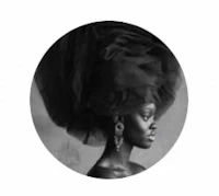 a black and white photograph of a woman with a large hat