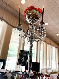 a table with a silver and black candle holder