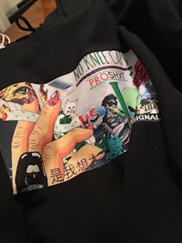 a black hoodie with a cartoon on it