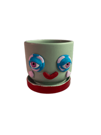 a 3d image of a green cup with a face on it
