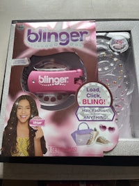 a box with a pink hair brush and a pink hair brush