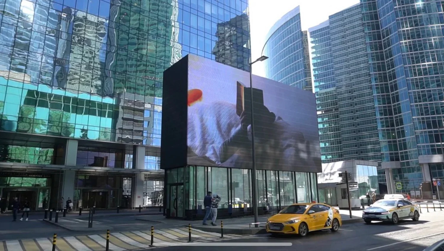a large digital billboard in the middle of a city