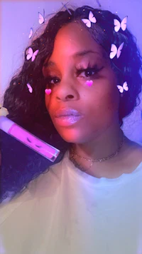 a woman with pink hair and butterflies on her face