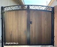 a wooden gate with wrought iron accents