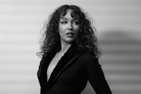 a black and white photo of a woman with curly hair