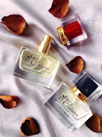 two bottles of perfume on a white cloth