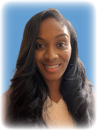 a woman with long hair smiling in front of a blue background