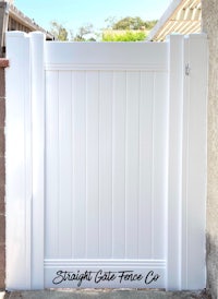a white gate in front of a house