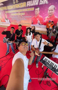 a group of people taking a selfie with musical instruments