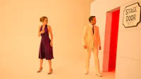 a man and woman standing in front of a door