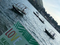 a group of small boats on the water with a sign