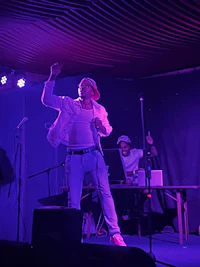 a man on stage with a microphone in his hand