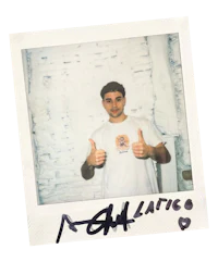 a man giving a thumbs up in front of a white wall