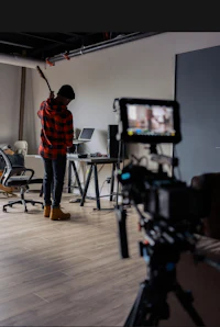 a man is standing in front of a camera in an office
