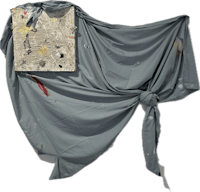 a piece of cloth with a piece of paper on it