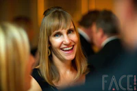 a woman smiling at a group of people