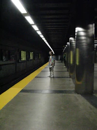 a person standing on a platform at a train station