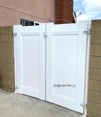 a white gate in front of a house