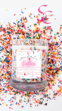 a candle with sprinkles on top of it