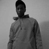 a black and white photo of a man in a hoodie