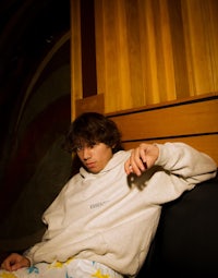 a man sitting on a couch with a skateboard