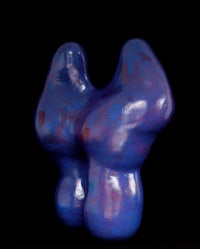 a blue sculpture on a black background