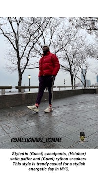 a man in a red jacket standing on a sidewalk