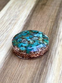 a turquoise stone on top of a wooden table