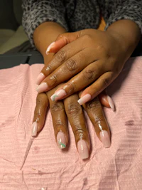 a woman's hands with pink nails on a pink sheet