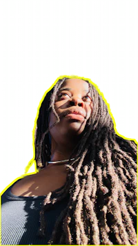 a woman with dreadlocks in front of a green background